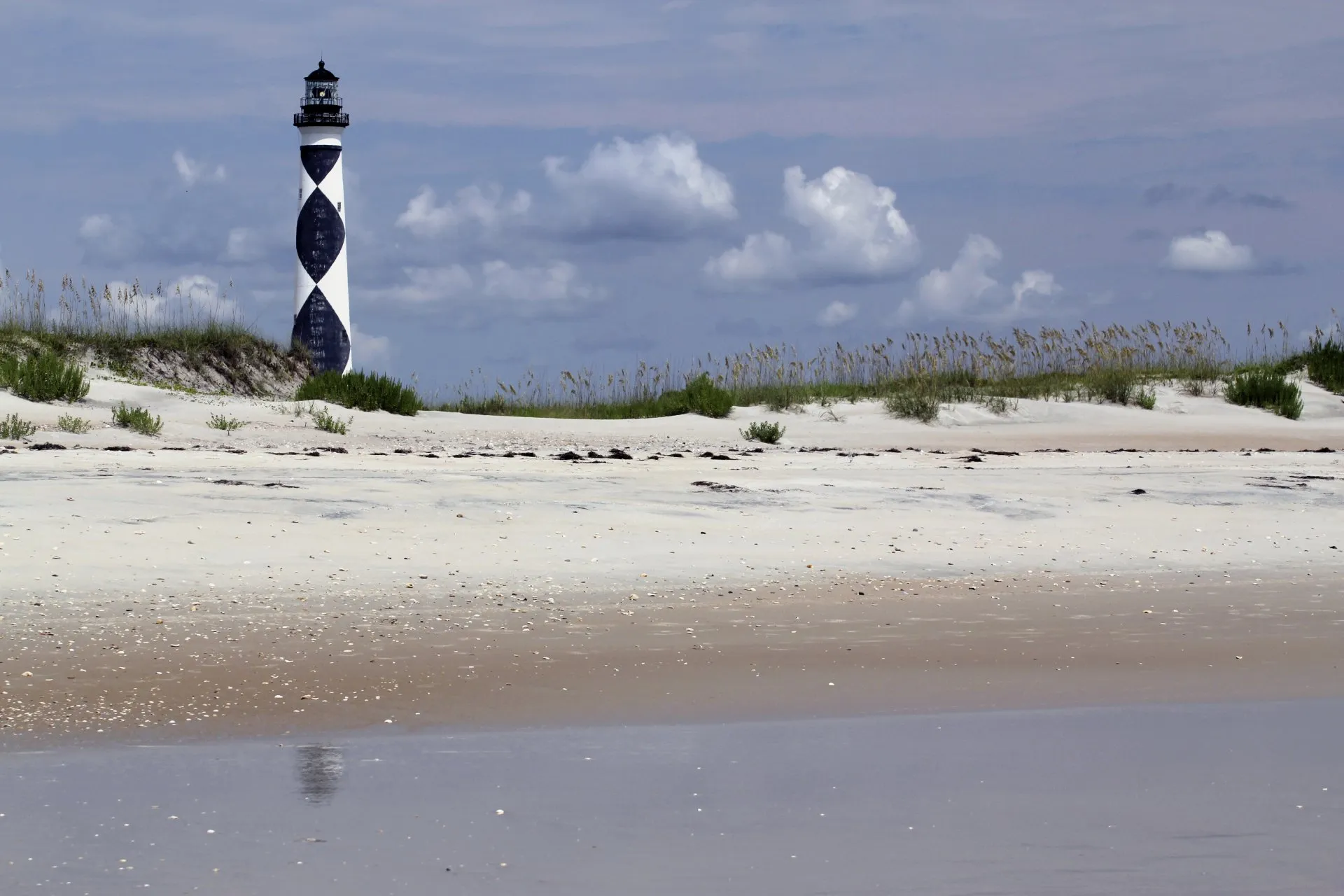 A wide view of a lighthouse by the shore
